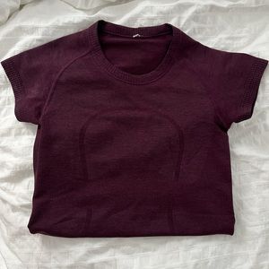 Plum /Merlot color swiftly tech lululemon short sleeve shirt size 2, hip length!